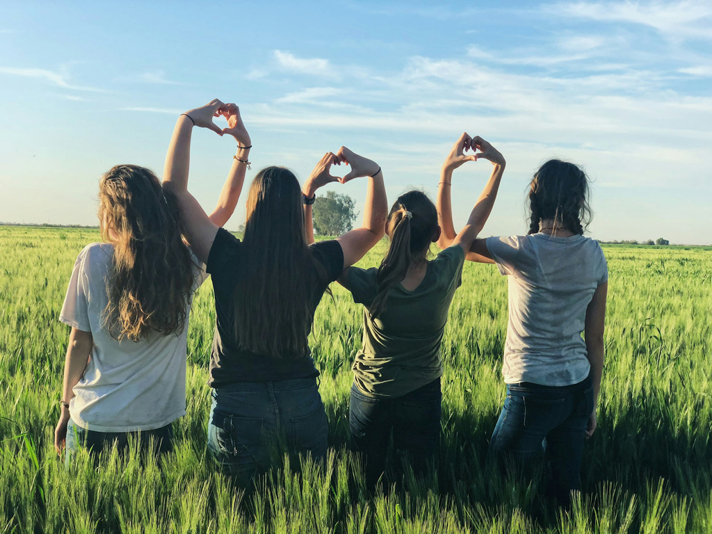 friends in wheat field outside